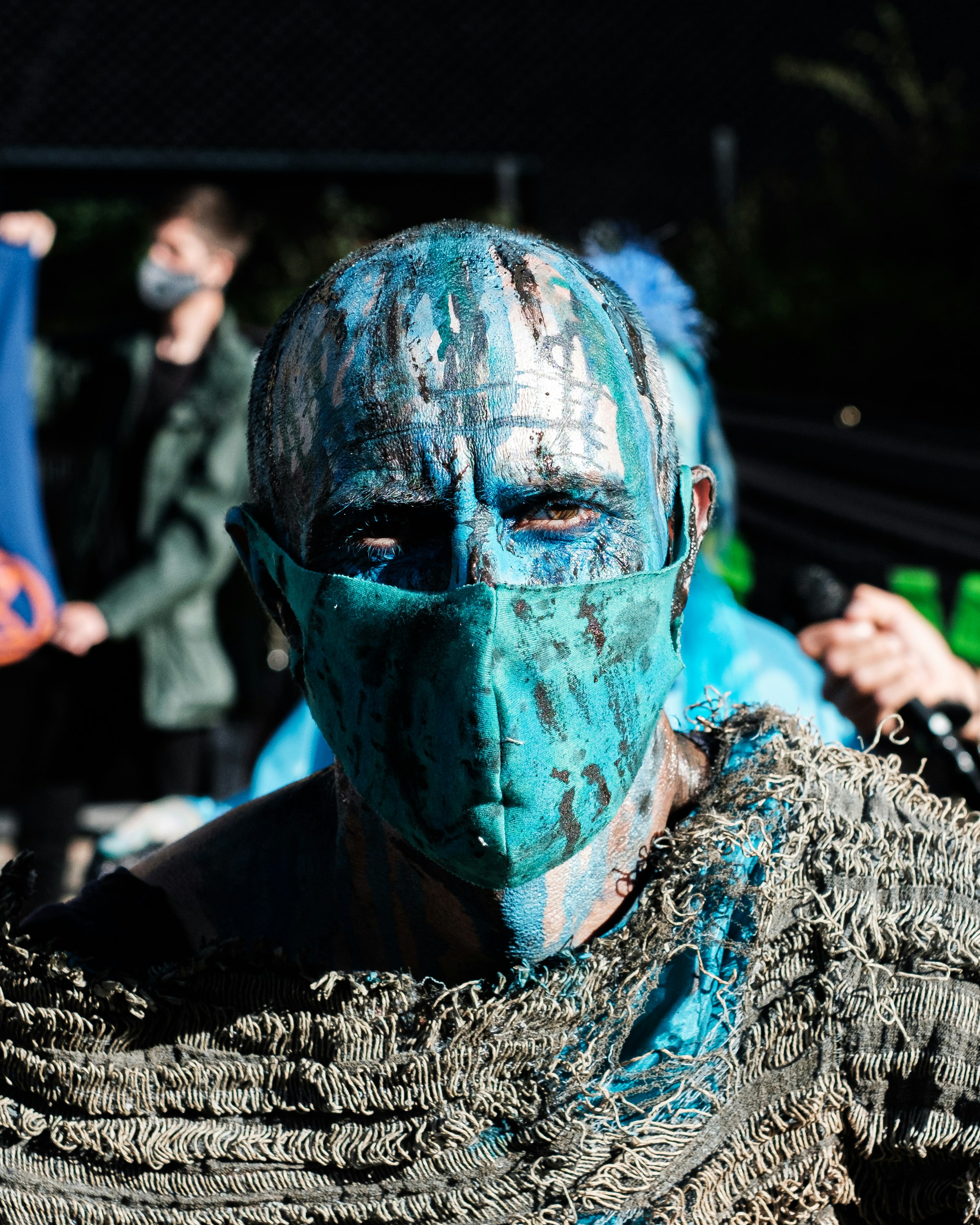 person in green and black mask